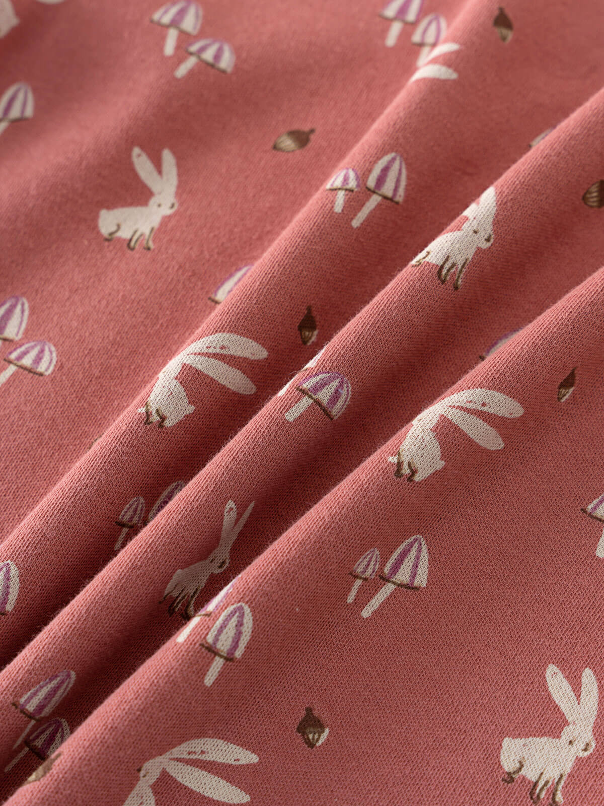 Close-up of coral pink fabric with mushroom and rabbit print pattern Printed Short Sleeve Tee - Forest Gathering Rosehip Girls