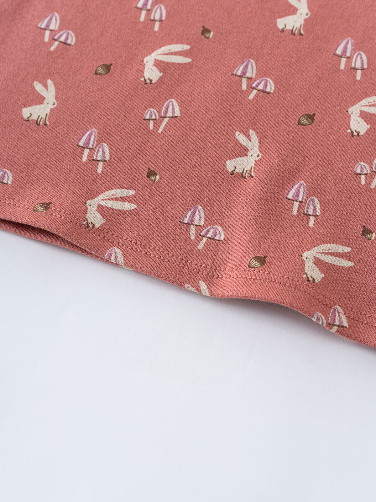 Close-up of coral fabric with white rabbits, mushrooms, and hedgehogs printed pattern Printed Short Sleeve Tee - Forest Gathering Rosehip Girls