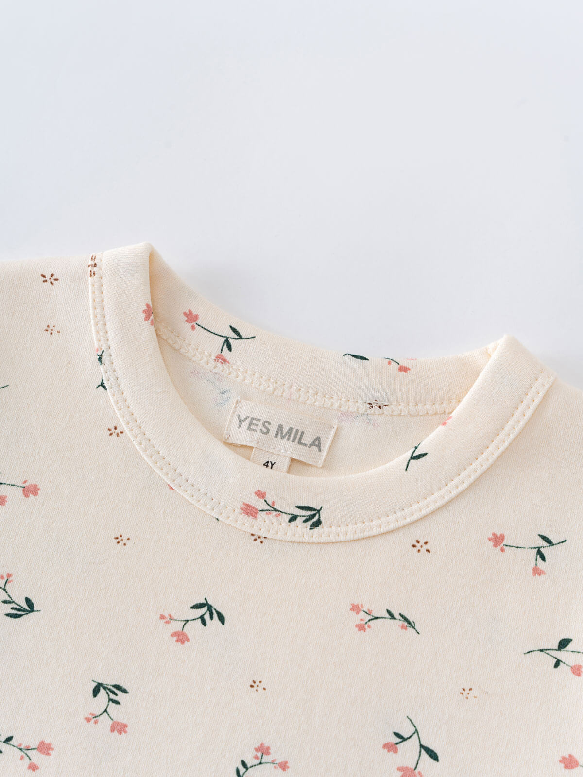 Close-up of cream-colored collar with small pink floral print pattern Printed Short Sleeve Tee - Wild Meadow Ecru Girls