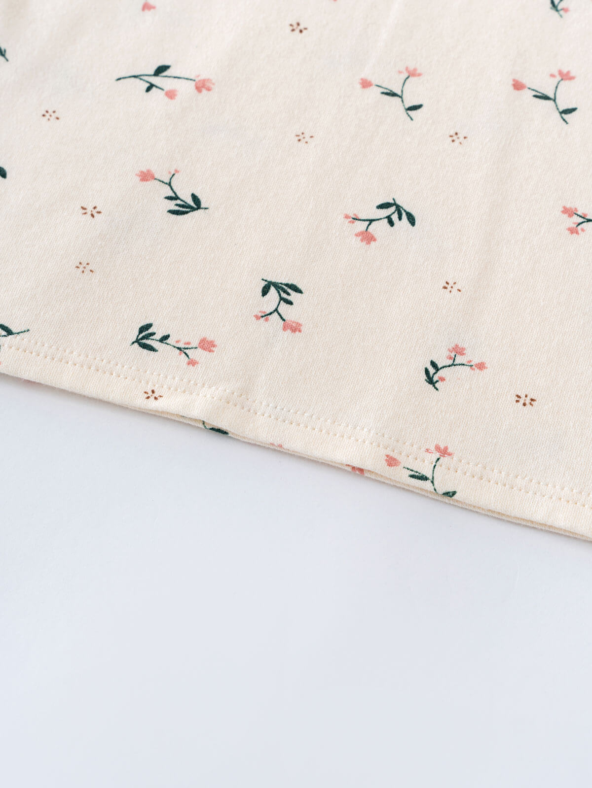 Close-up of cream fabric with small pink flowers and green leaves pattern Printed Short Sleeve Tee - Wild Meadow Ecru Girls