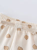 Close-up of cream-colored baby pants with small bear print pattern Printed Sweatpants - Cosy Bear Ecru Baby boy
