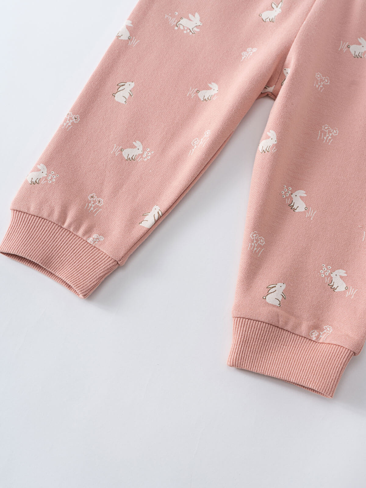 Close-up of pink sweatpants with white bunny and flower print pattern Printed Sweatpants - Meadow Friends Blush Baby girl