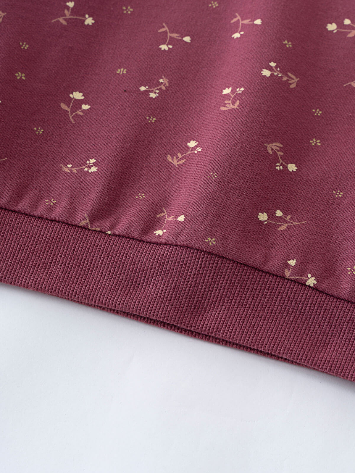 Close-up of burgundy fabric with small floral print and ribbed hem detail Printed Sweatshirt - Wild Meadow Plum Jam Girls
