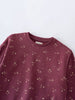 Close-up of a maroon sweatshirt with small floral print pattern Printed Sweatshirt - Wild Meadow Plum Jam Girls