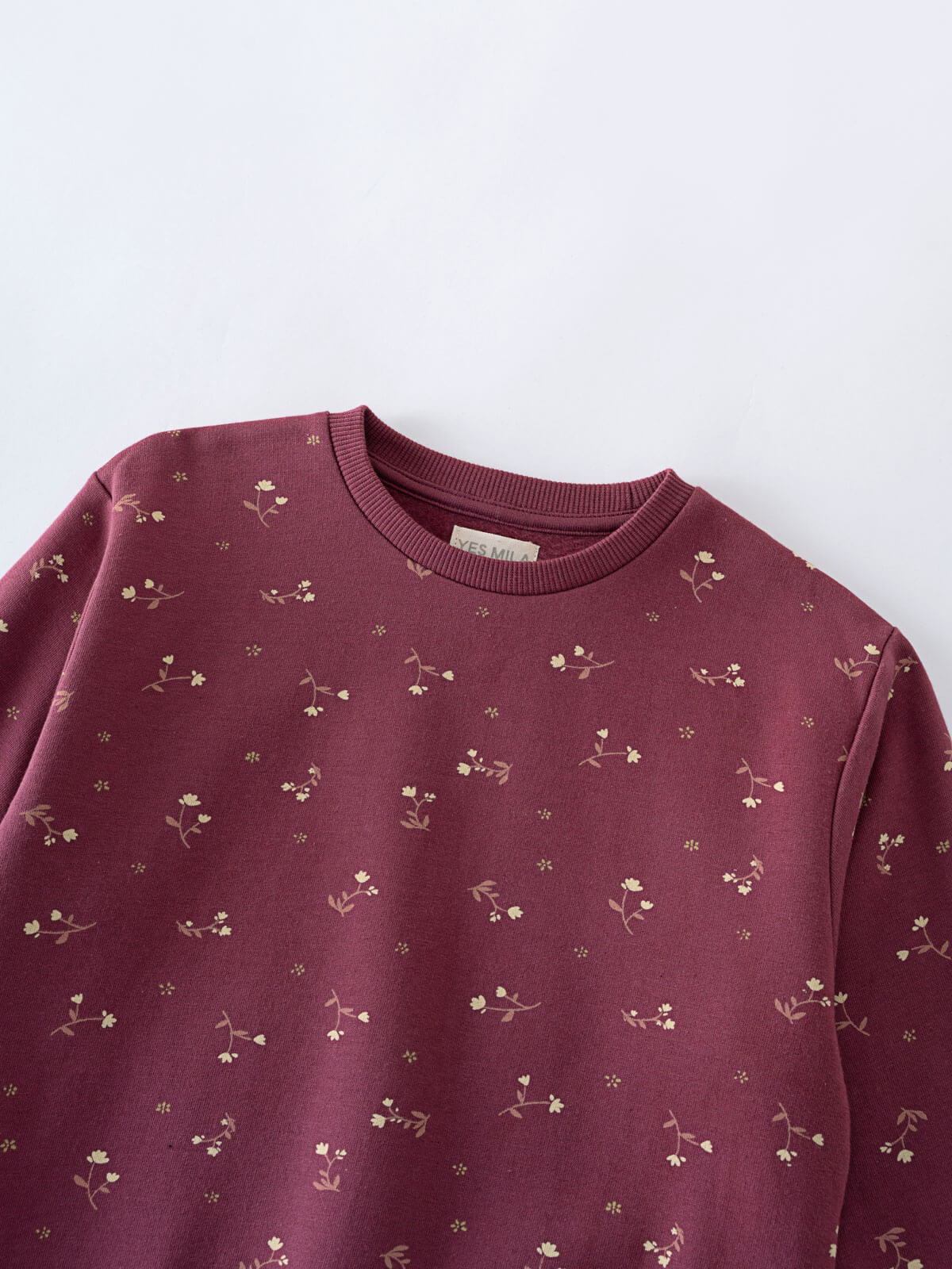 Close-up of a maroon sweatshirt with small floral print pattern Printed Sweatshirt - Wild Meadow Plum Jam Girls