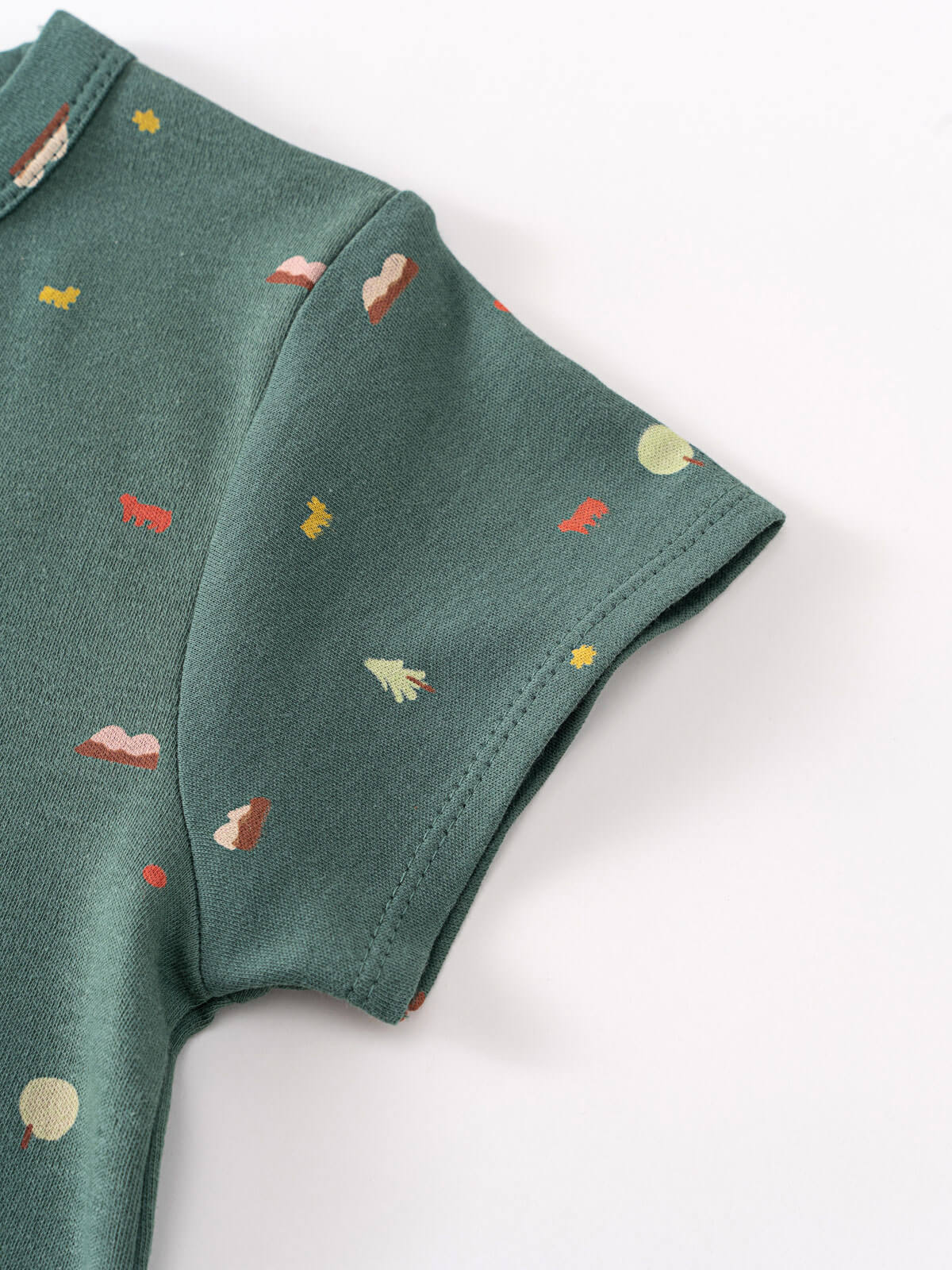 Close-up of green fabric with small embroidered mushroom and tree pattern Baby Printed Short Sleeve Tee - Mountain View Ecru Baby boy