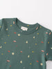 Close-up of a green tee with small printed patterns including trees and stars Baby Printed Short Sleeve Tee - Mountain View Ecru Baby boy
