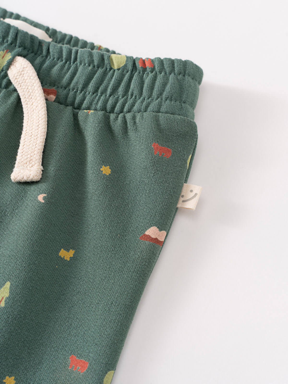 Close-up of green sweatpants with small animal and nature print details Printed Sweatpants - Mountain View Balsam Baby boy