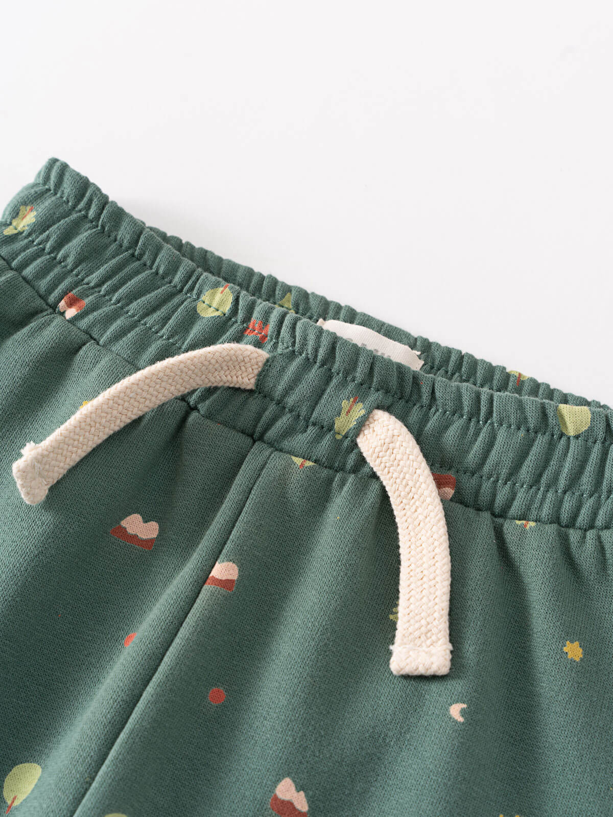 Close-up of green sweatpants waistband with cream drawstring and small printed pattern Printed Sweatpants - Mountain View Balsam Baby boy
