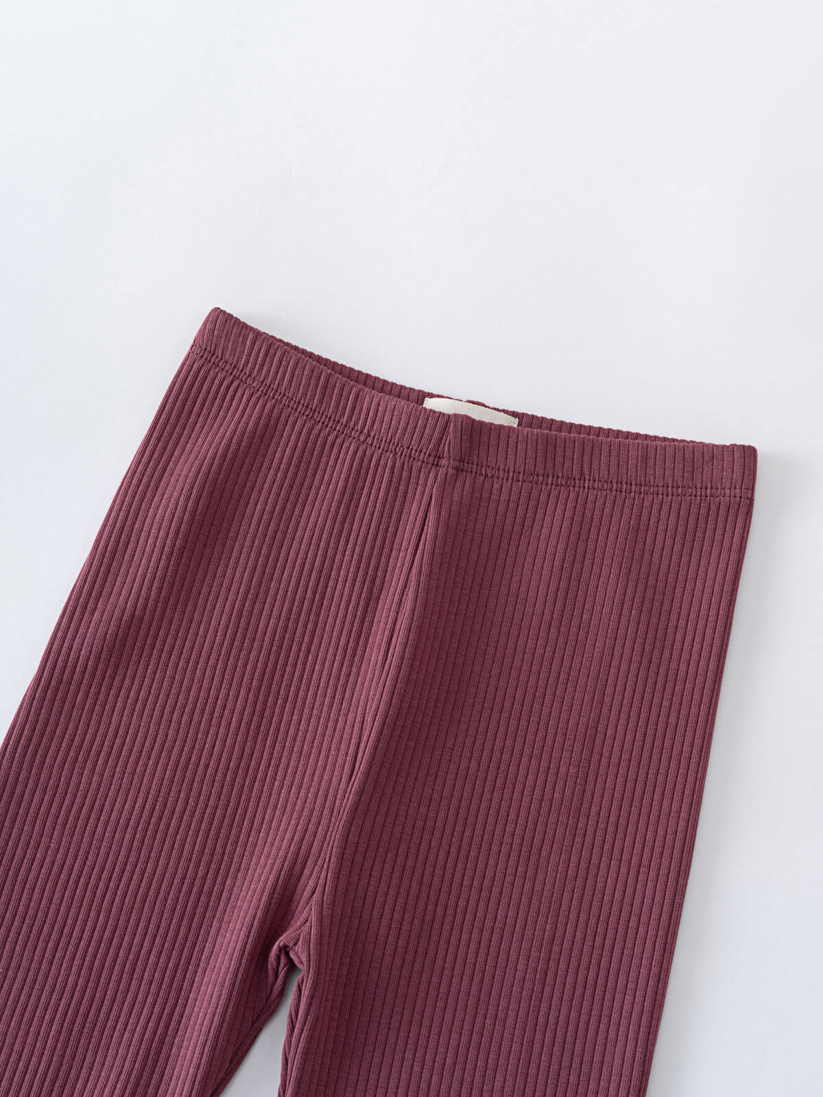 Close-up of burgundy ribbed leggings with elastic waistband on white background Ribbed Leggings - Plum Jam Girls