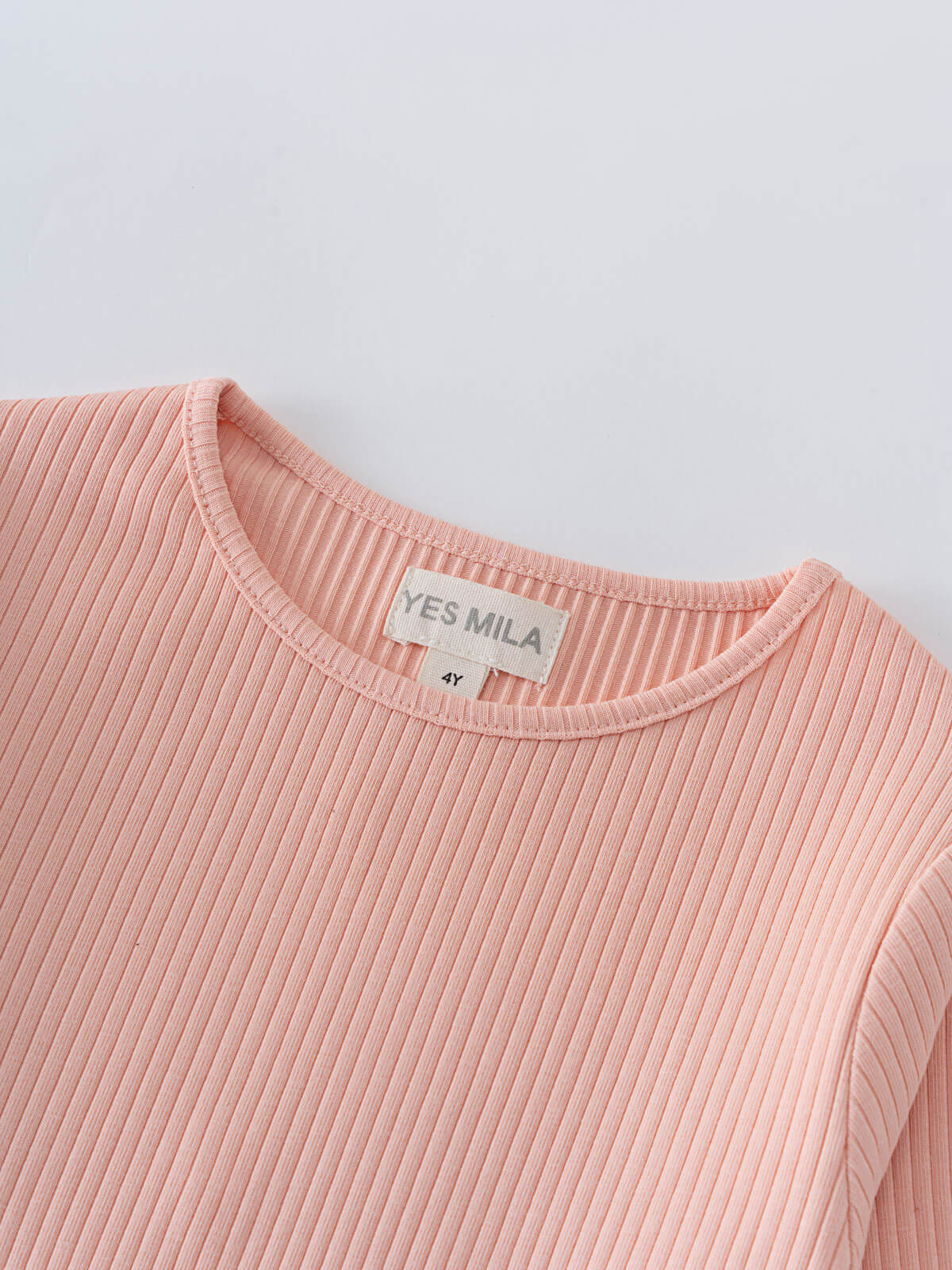 Close-up of a pink ribbed long sleeve shirt collar with label Ribbed Long Sleeve Tee - Mallow Girls