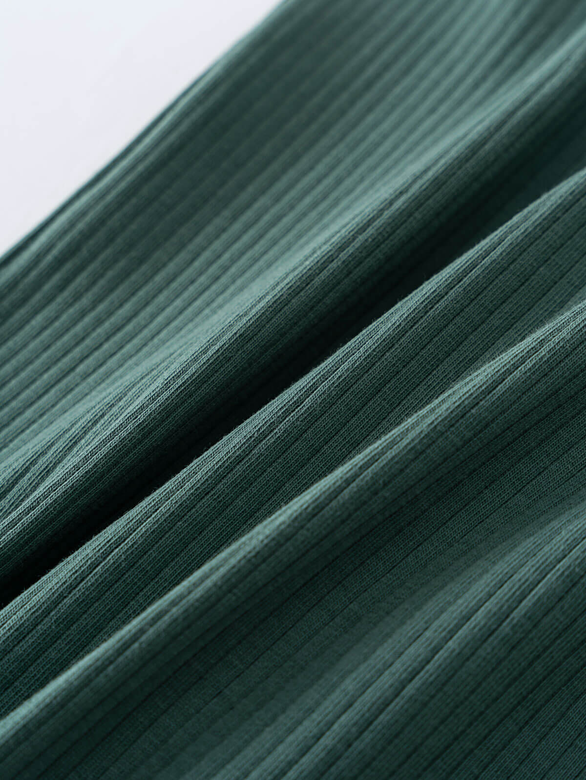 Close-up of dark green ribbed fabric with vertical textured lines Ribbed Long Sleeve One Piece - Balsam Baby boy