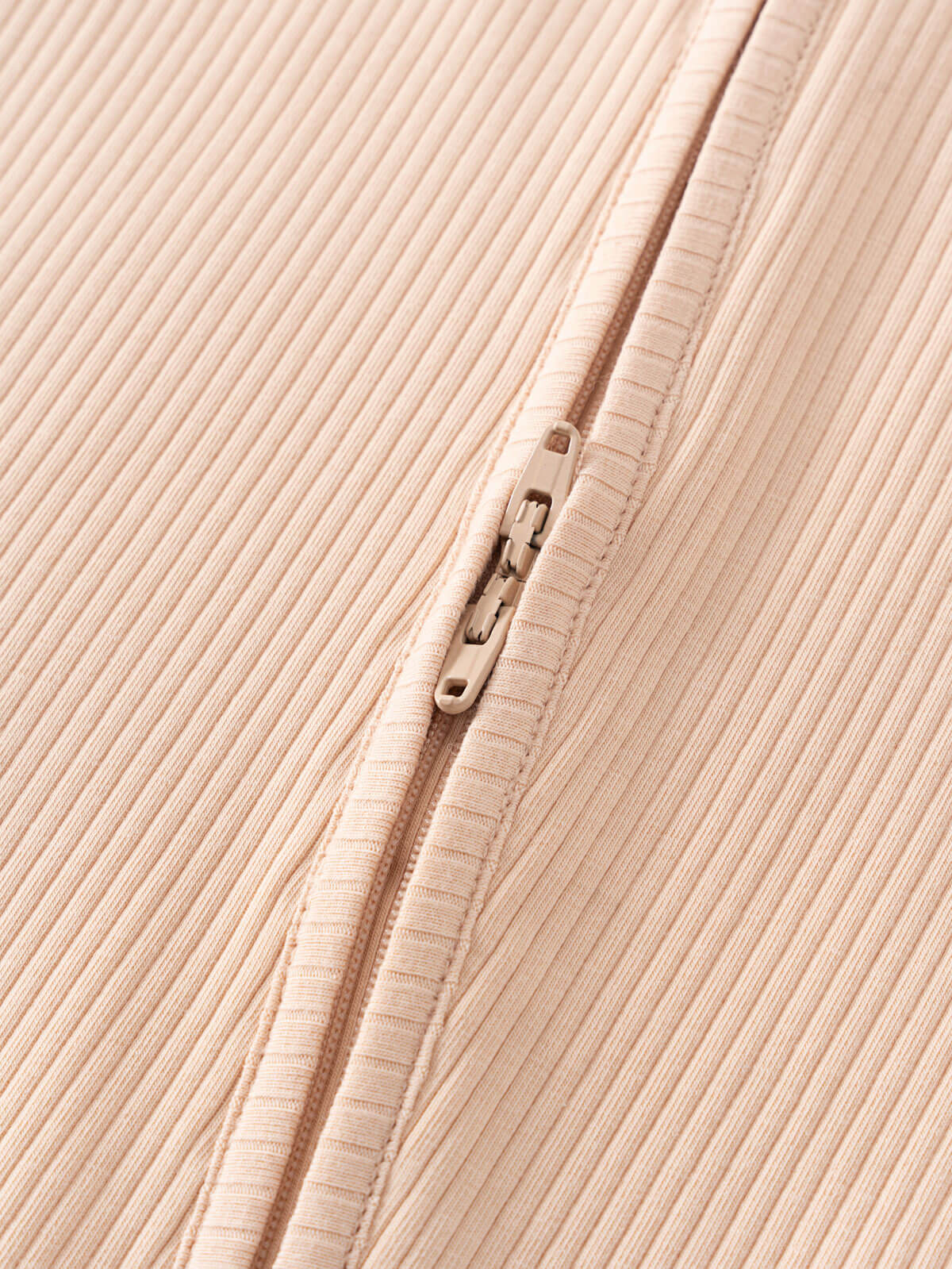 Close-up of a beige ribbed fabric with a zipper detail Ribbed Long Sleeve One Piece - Clay Baby girl