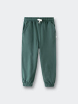 Green sweatpants with elastic cuffs and white drawstring on gray background Sweatpants - Balsam Boys
