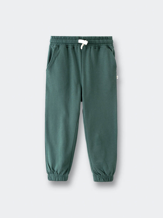 Green sweatpants with elastic cuffs and white drawstring on gray background Sweatpants - Balsam Boys