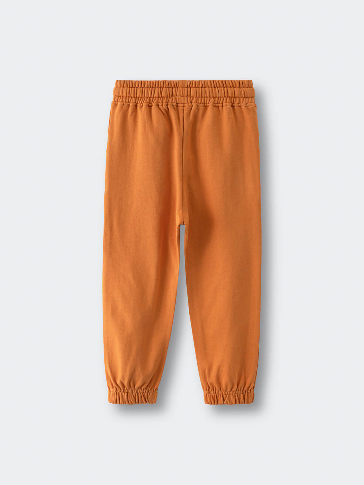 Orange sweatpants with elastic waistband and cuffed ankles laid flat Sweatpants - Pumpkin Boys