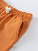 Close-up of orange sweatpants waistband with white drawstring and pocket detail Sweatpants - Pumpkin Boys