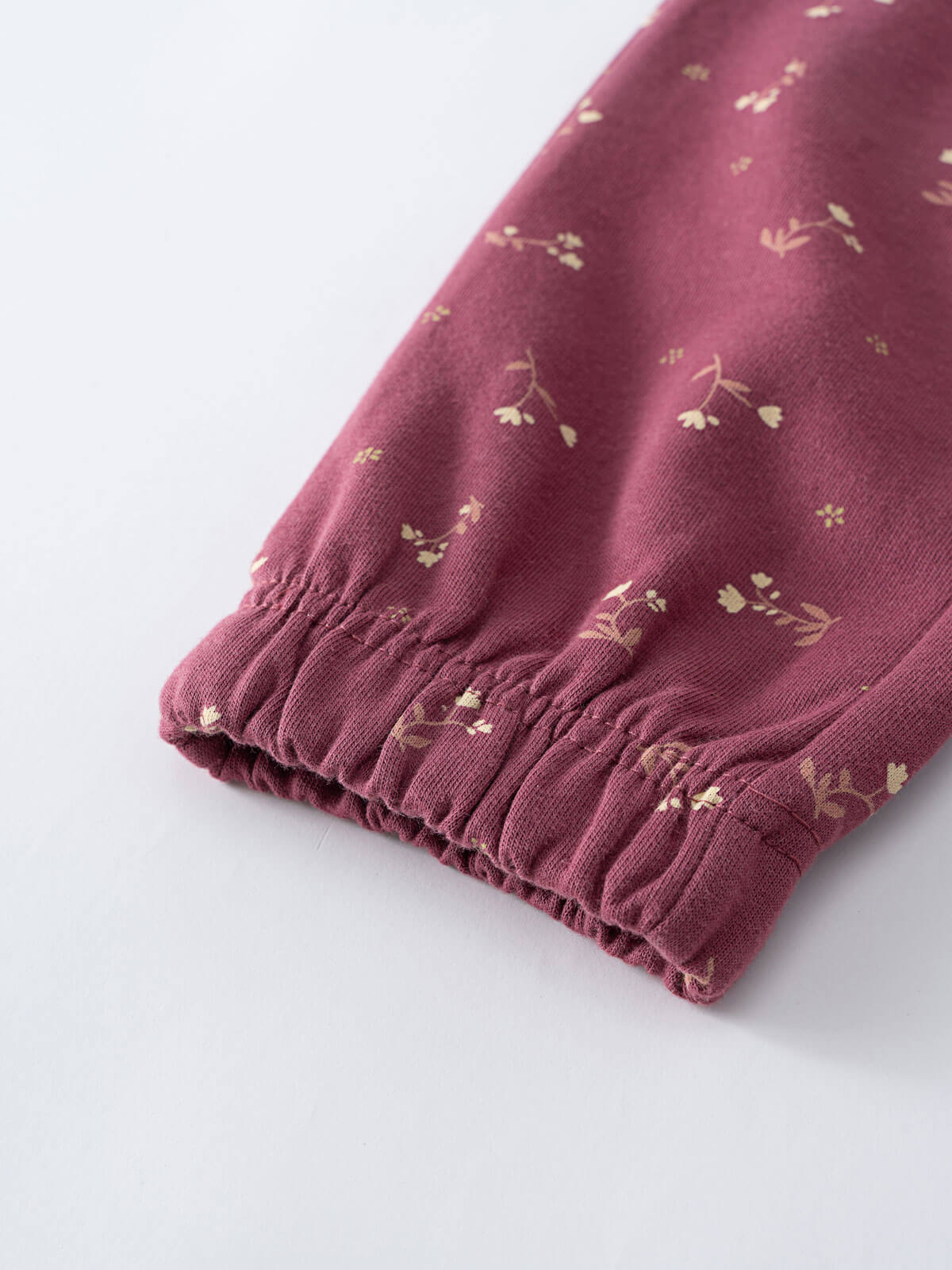 Close-up of burgundy fabric cuff with small floral print pattern Sweatpants - Wild Meadow Plum Jam Girls