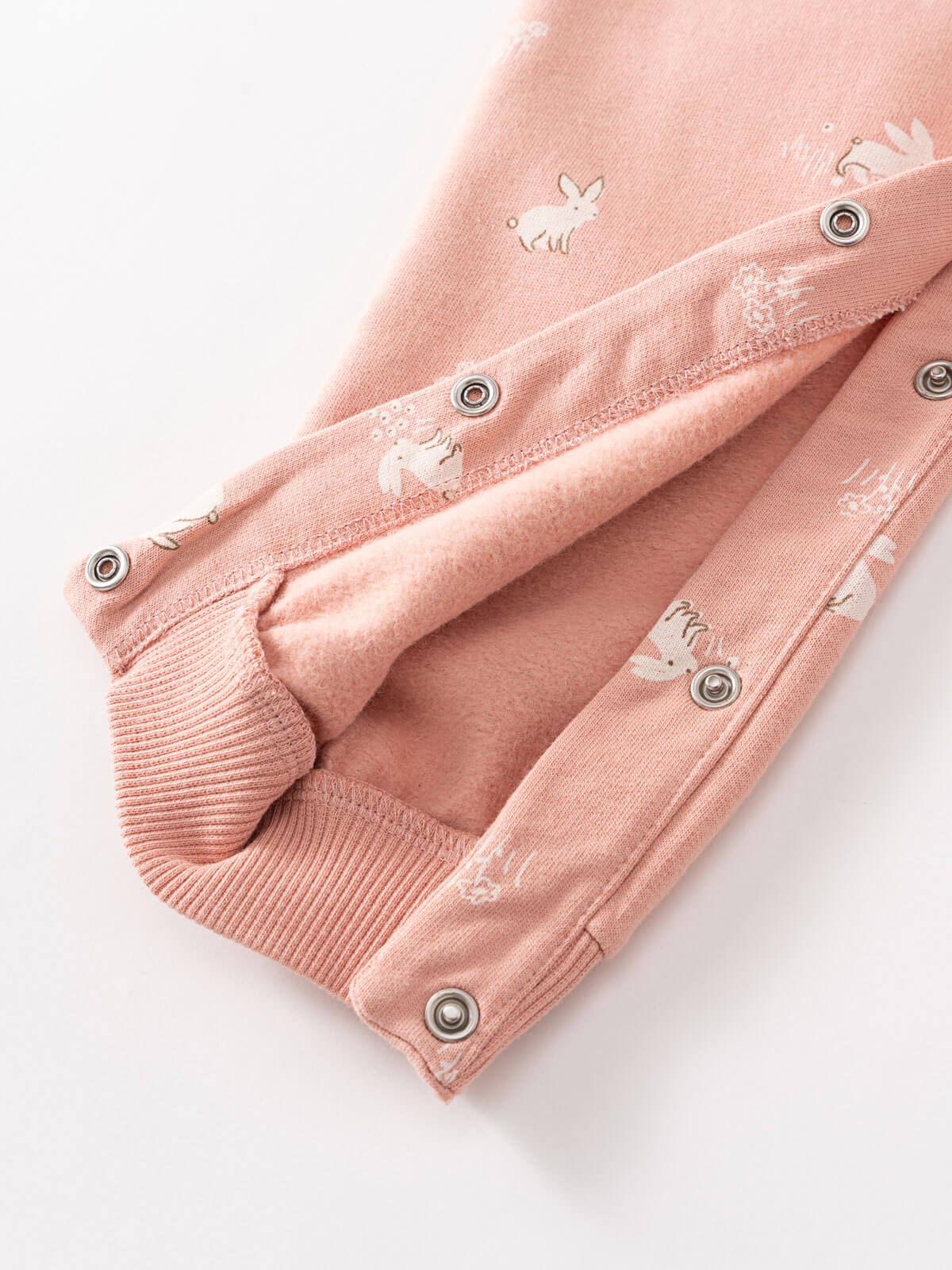 Close-up of pink baby onesie with animal print and snap buttons Sweatshirt Onesie - Meadow Friends Blush Baby girl