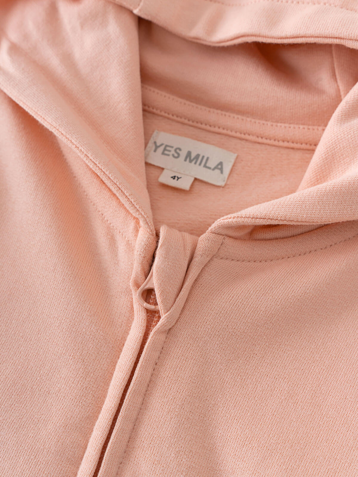 Close-up of a peach hoodie showing zipper and label detail Zip Hoodie - Mallow Boys