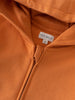Close-up of an orange zip hoodie showing zipper and label detail Zip Hoodie - Pumpkin Boys