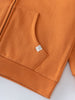 Close-up of orange hoodie pocket with small white label and ribbed hem Zip Hoodie - Pumpkin Boys