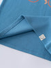 Close-up of blue t-shirt hem with small smiley face label detail Axel Short Sleeve Tee - Milo Biking Boys