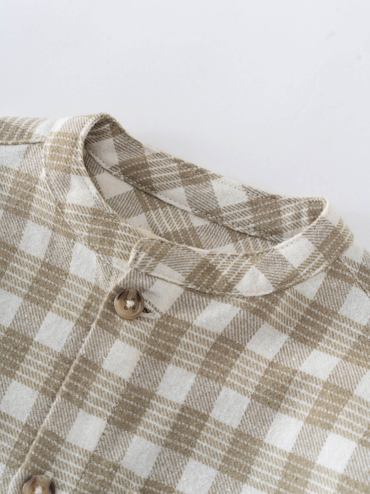 Close-up of a plaid shirt with a button on a white background Baby Check Shirt - Woven Check Baby boy