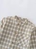 Close-up of a brown and white checkered shirt on a light gray background Baby Check Shirt - Woven Check Baby boy