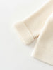 Knitted cream-colored cardigan on a white background Baby Cotton Cardigan - Ecru Baby boy