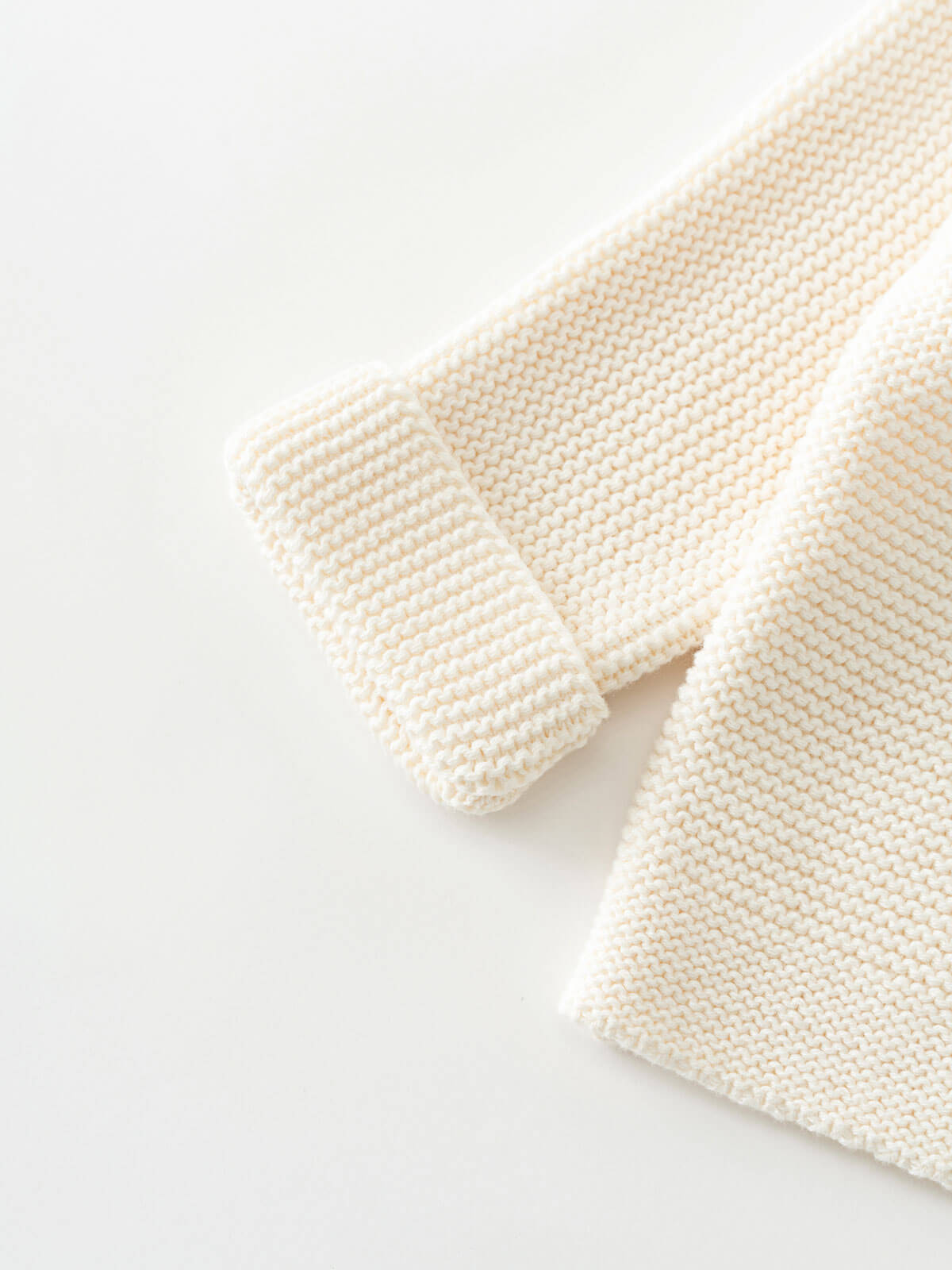 Knitted cream-colored cardigan on a white background Baby Cotton Cardigan - Ecru Baby boy