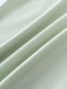 Close-up of soft light green fabric with gentle folds and texture Baby Henley Tee - Matcha Baby boy