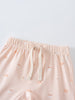Close-up of pale pink shorts with apple print and cream drawstring Baby Jersey Shorts - Apples Baby girl