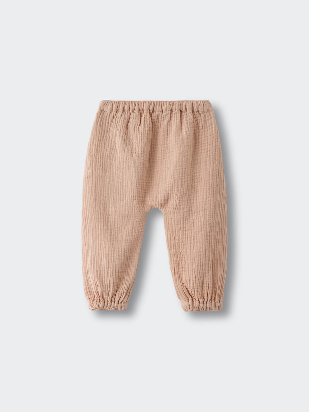 Beige textured pants with elastic waist and cuffs on light background Baby Muslin Pants - Sand Baby boy