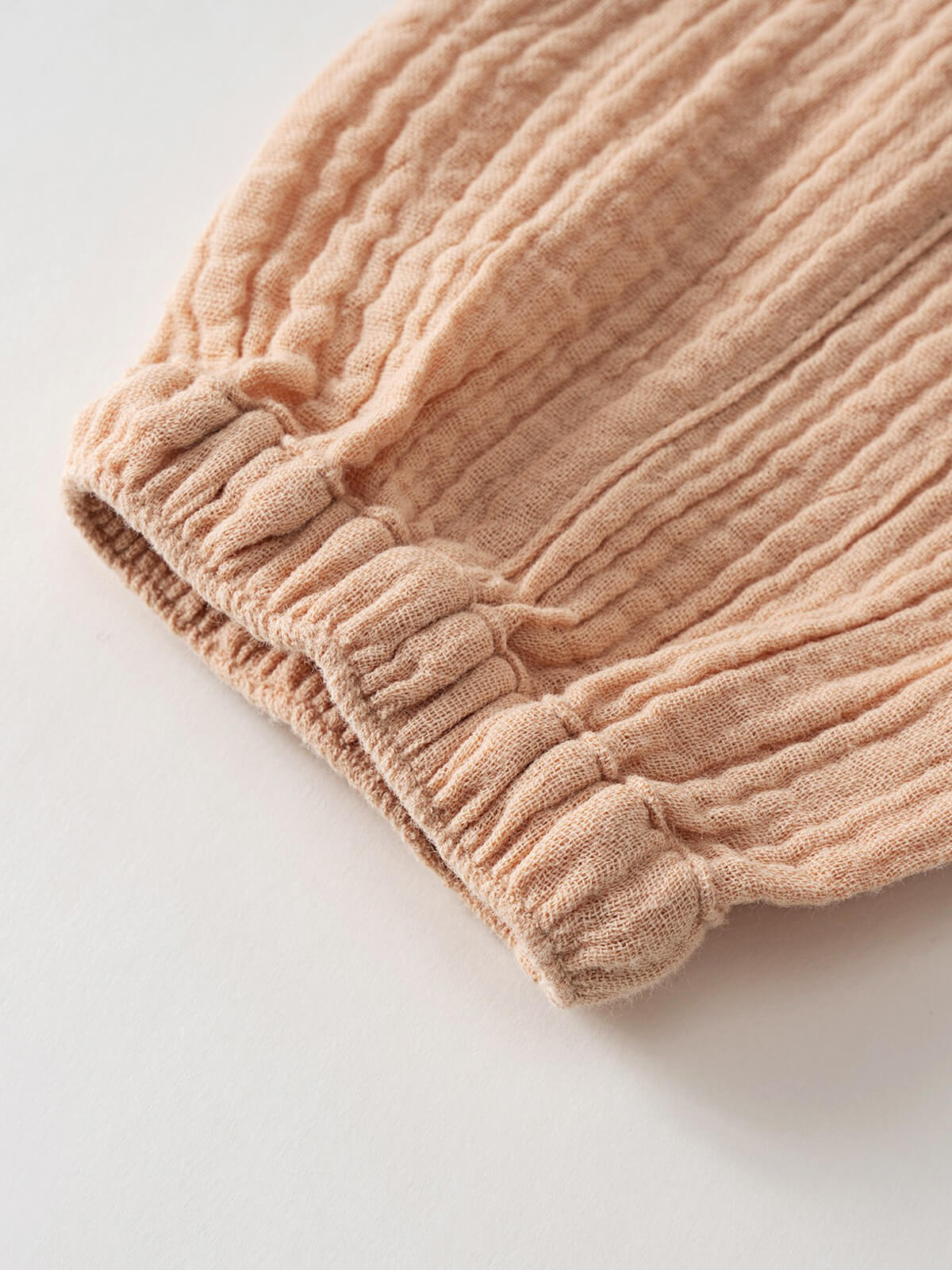 Close-up of beige ribbed fabric with gathered elastic waistband detail Baby Muslin Pants - Sand Baby boy