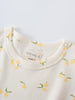 Close-up of cream-colored baby shirt collar with yellow lemon print pattern Baby Printed Short Sleeve Tee- Lemons Baby girl