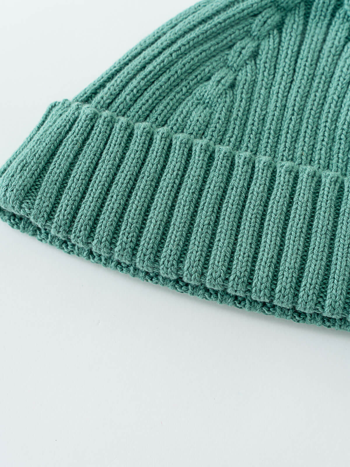 Close-up of a teal knit beanie on a light gray background Baby Ribbed Beanie - Balsam Baby boy