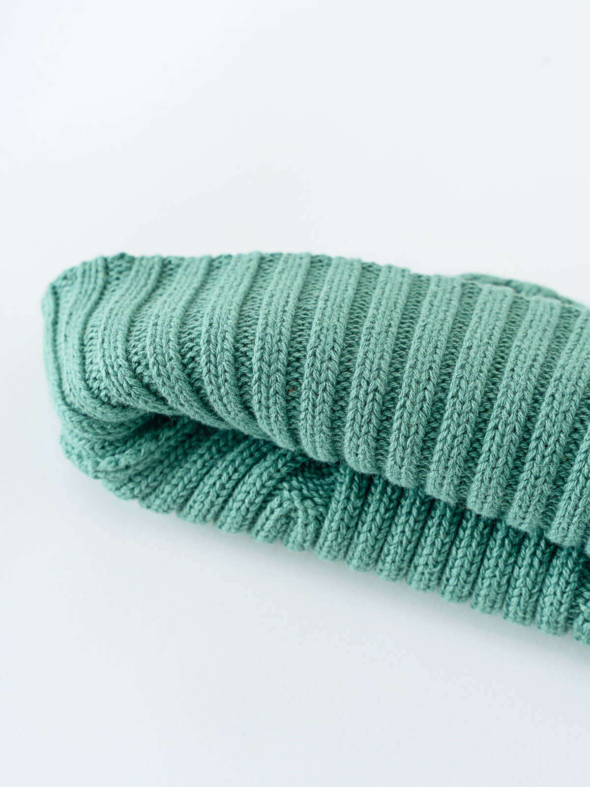Folded teal knitted sock on a white background Baby Ribbed Beanie - Balsam Baby boy