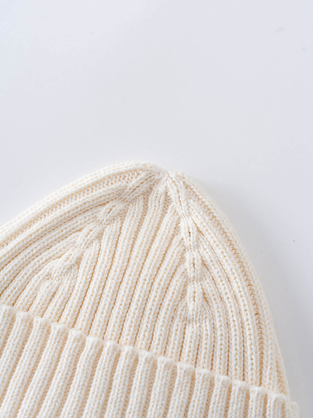 Close-up of a beige knit beanie on a light gray background Baby Ribbed Beanie - Ecru Baby boy