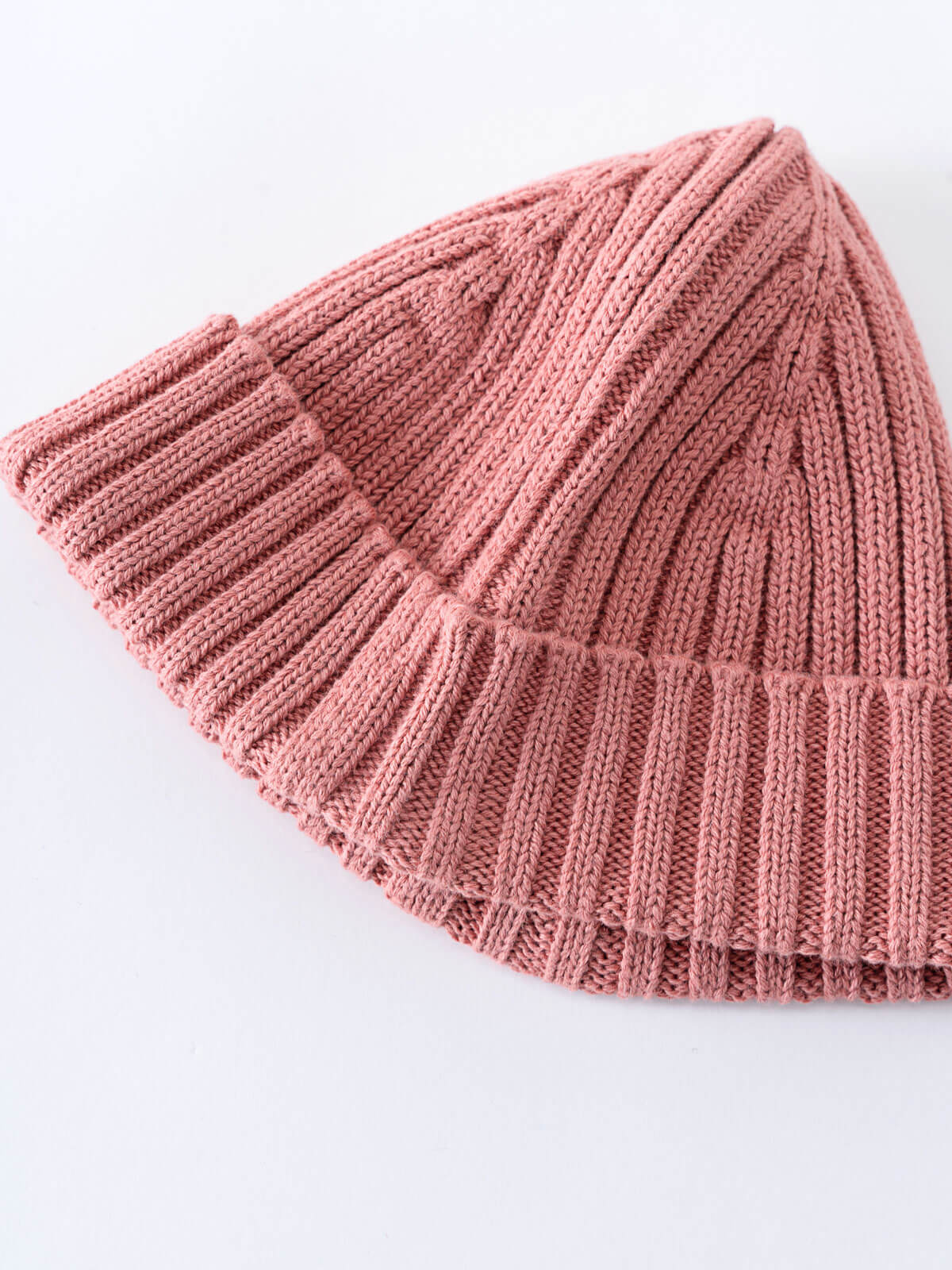 Pink knitted beanie on a white background Baby Ribbed Beanie - Rosehip Baby girl