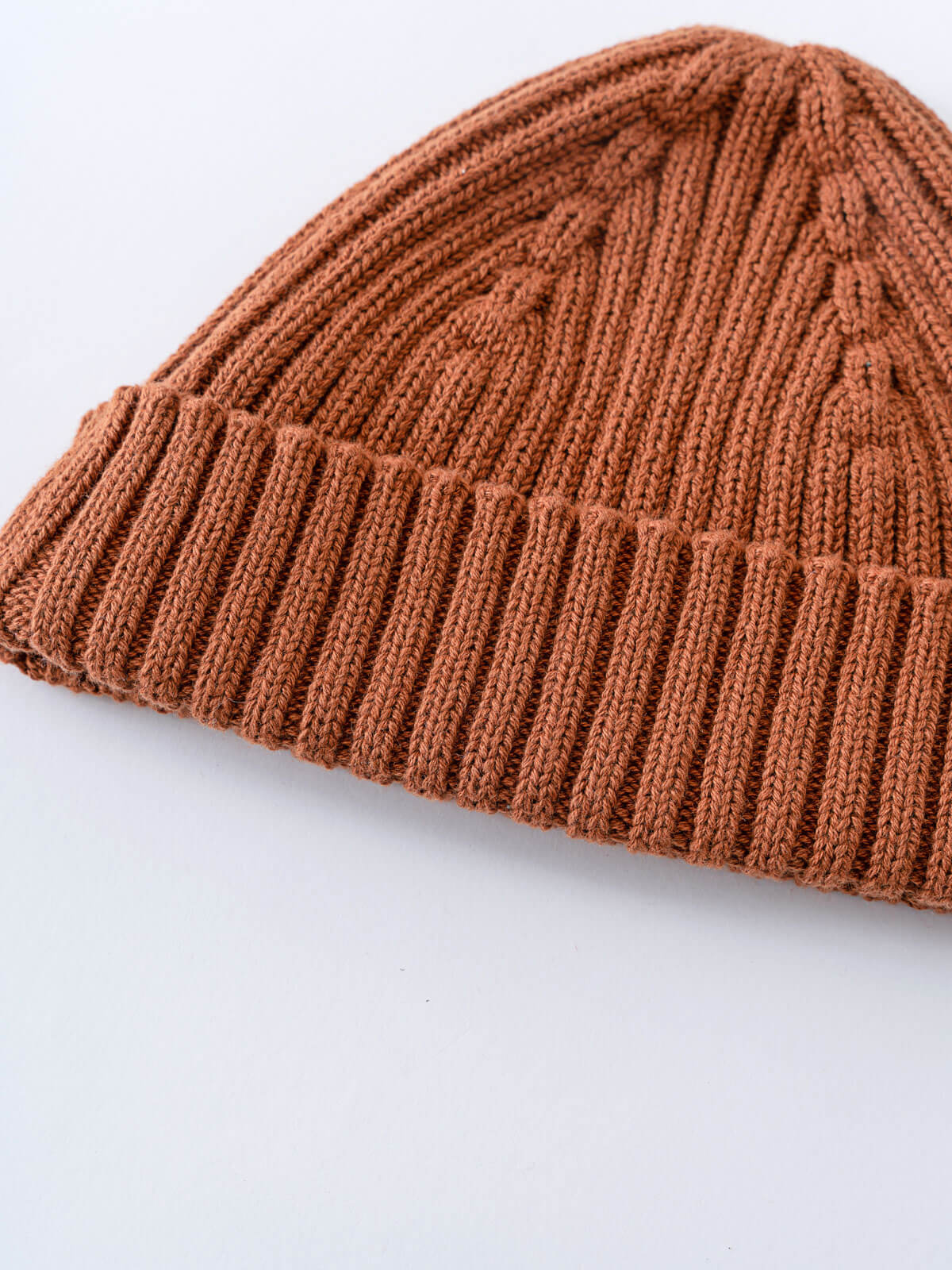 Brown knitted beanie on a light gray background Baby Ribbed Beanie - Russet Baby boy