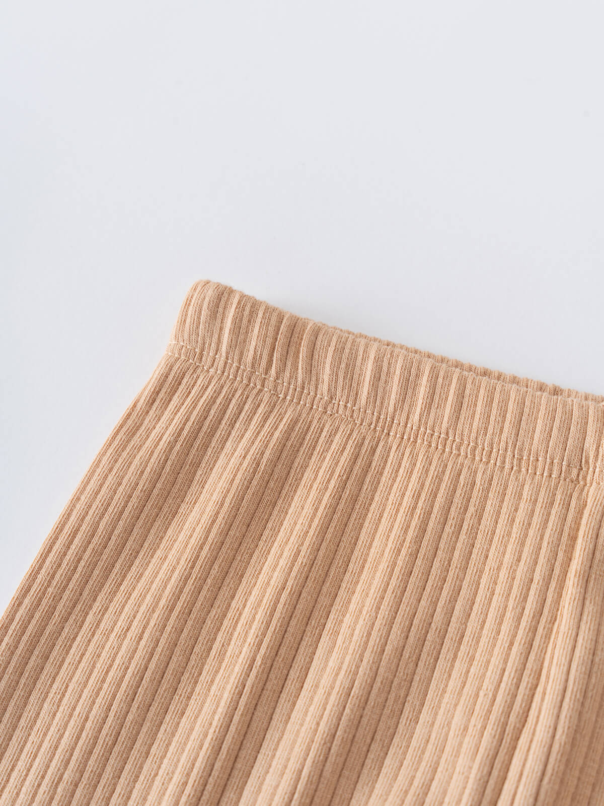 Close-up of ribbed beige fabric waistband on leggings Baby Ribbed Leggings - Sand Baby boy