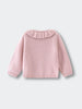 Pink knitted cardigan with a ruffled collar on a light gray background