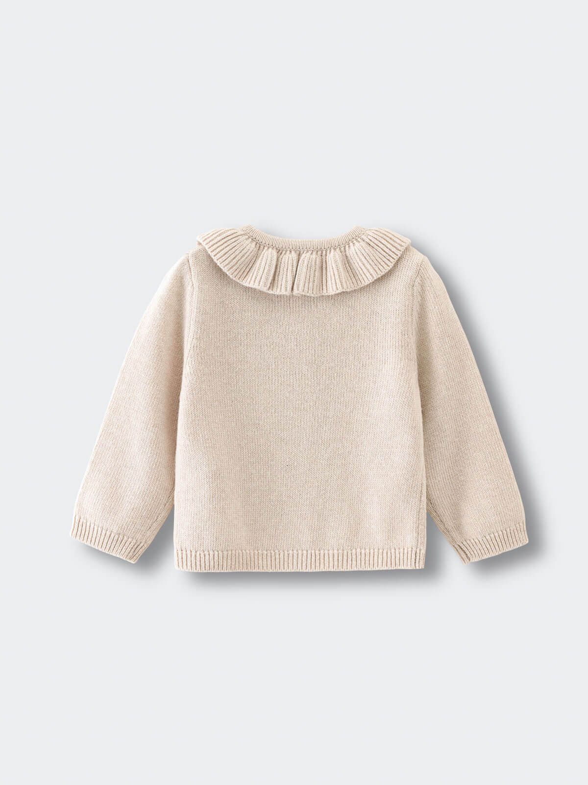 Beige sweater with a ruffled collar on a light gray background