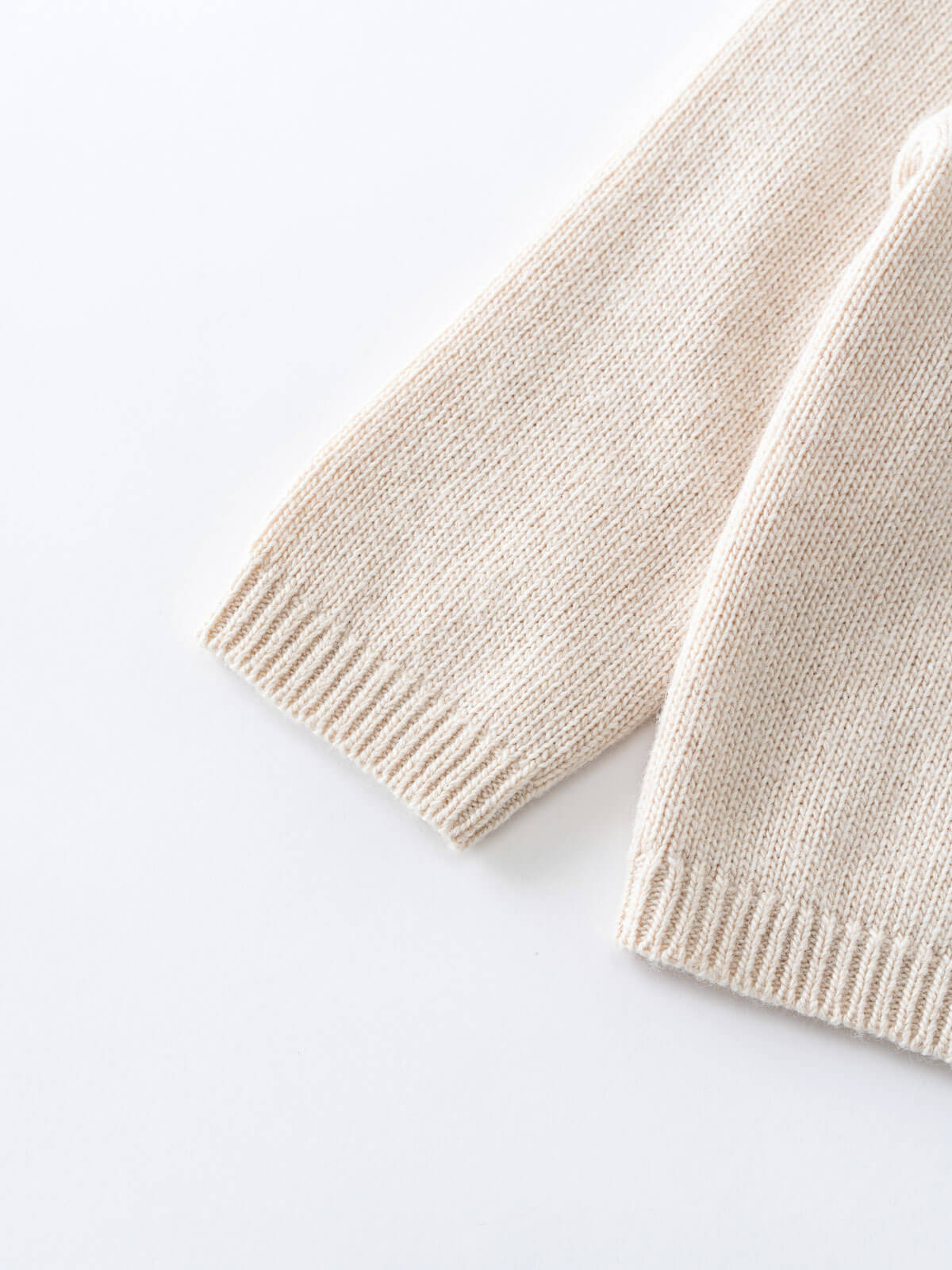 Beige knitted scarf on a white background