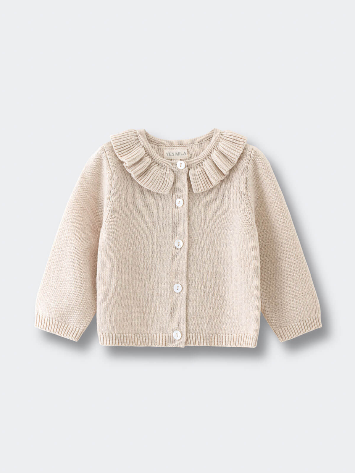 Beige cardigan with ruffled collar on a light gray background