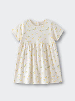 White dress with yellow lemon print pattern on a flat surface Baby Short Sleeve Jersey Dress - Lemons Baby girl