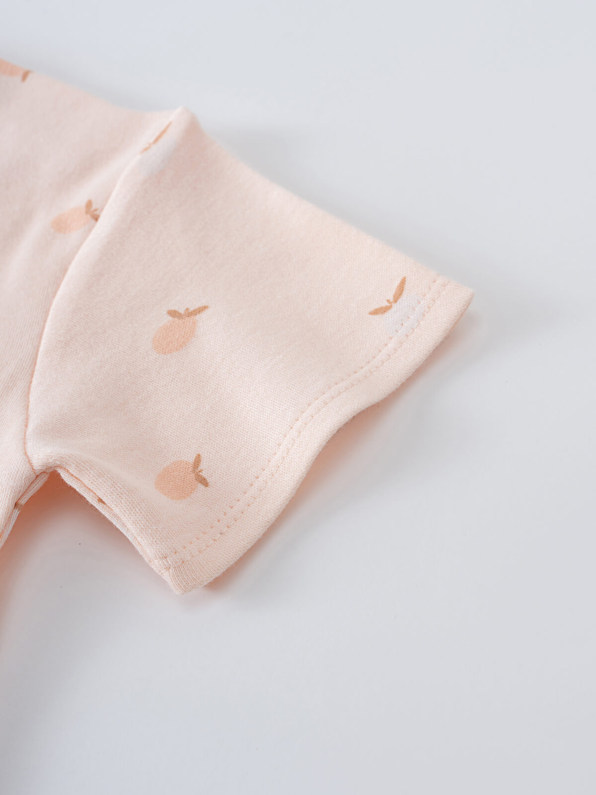 Close-up of a pale pink sleeve with small embroidered apple details Baby Printed Short Sleeve Tee - Apples Baby girl