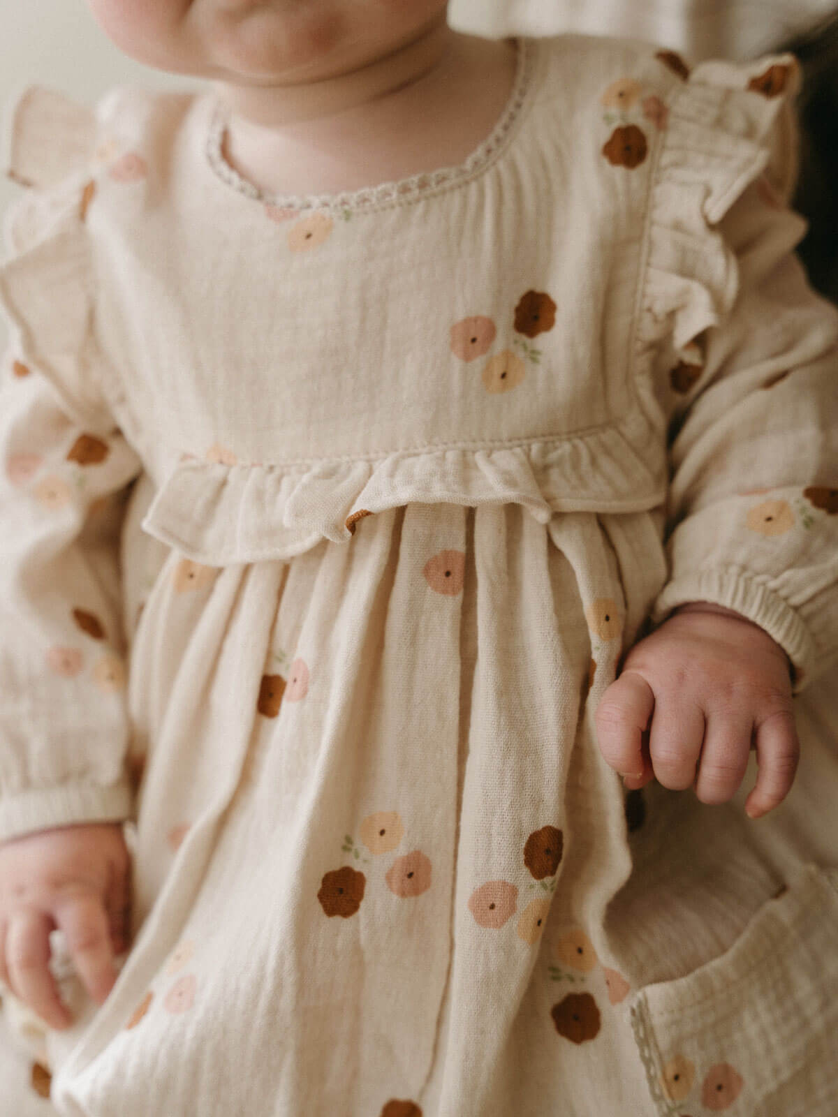 Baby wearing a floral dress with a soft focus background Baby Woven Dress - Autumn Bouquet Ecru Baby girl