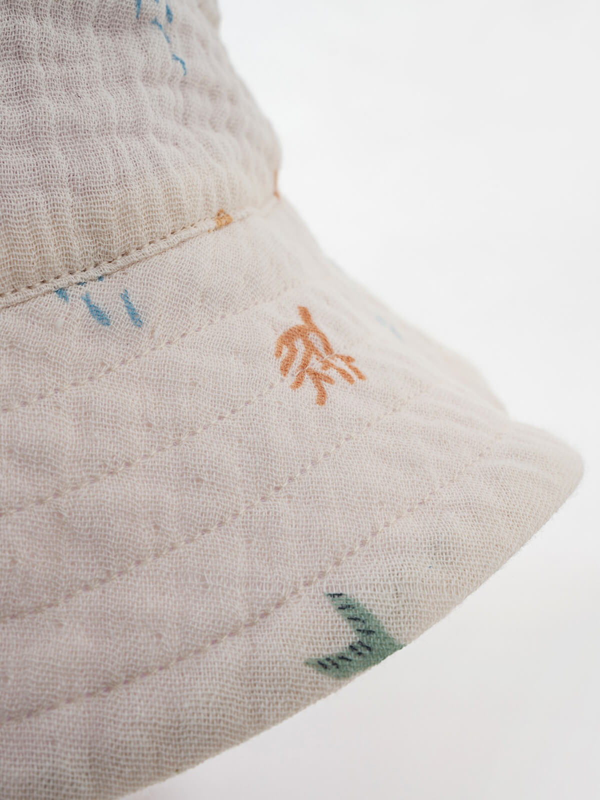 Close-up of natural muslin bucket hat with small sealife designs Bucket Hat - Dolphin Fun Girls